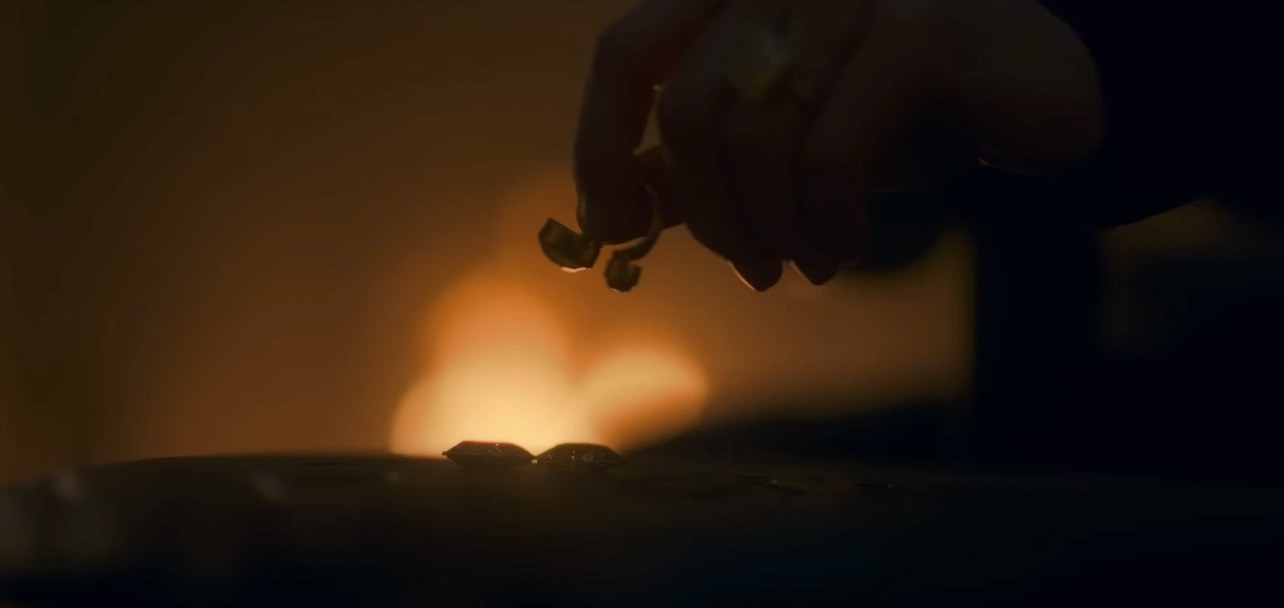 A ring is placed on a table in a dark room