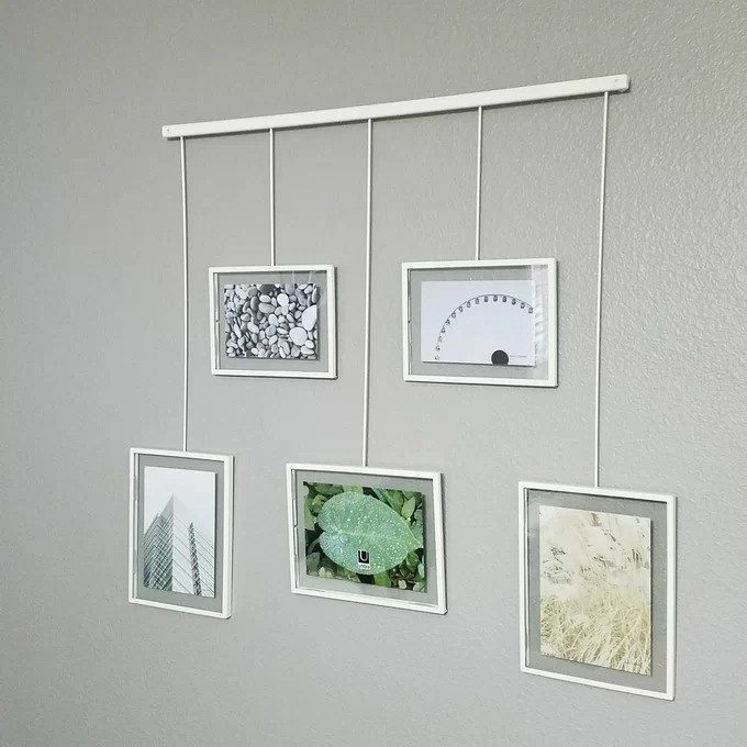 a reviewer photo of the white collage frame hanging on a wall