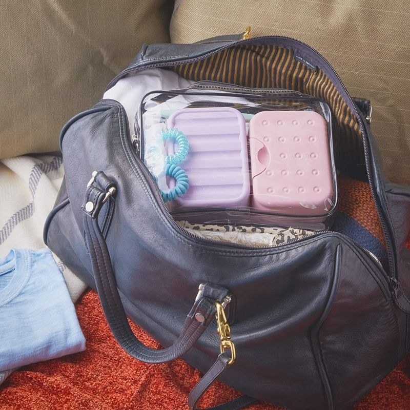 the pink and purple soap cases in a bag
