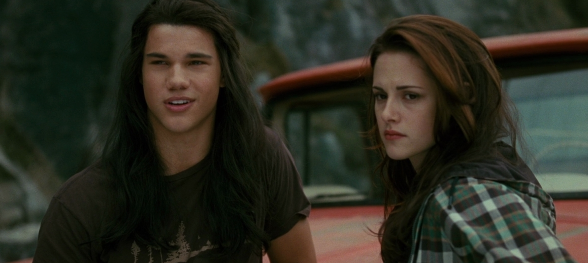 Bella and Jacob standing in front of her truck