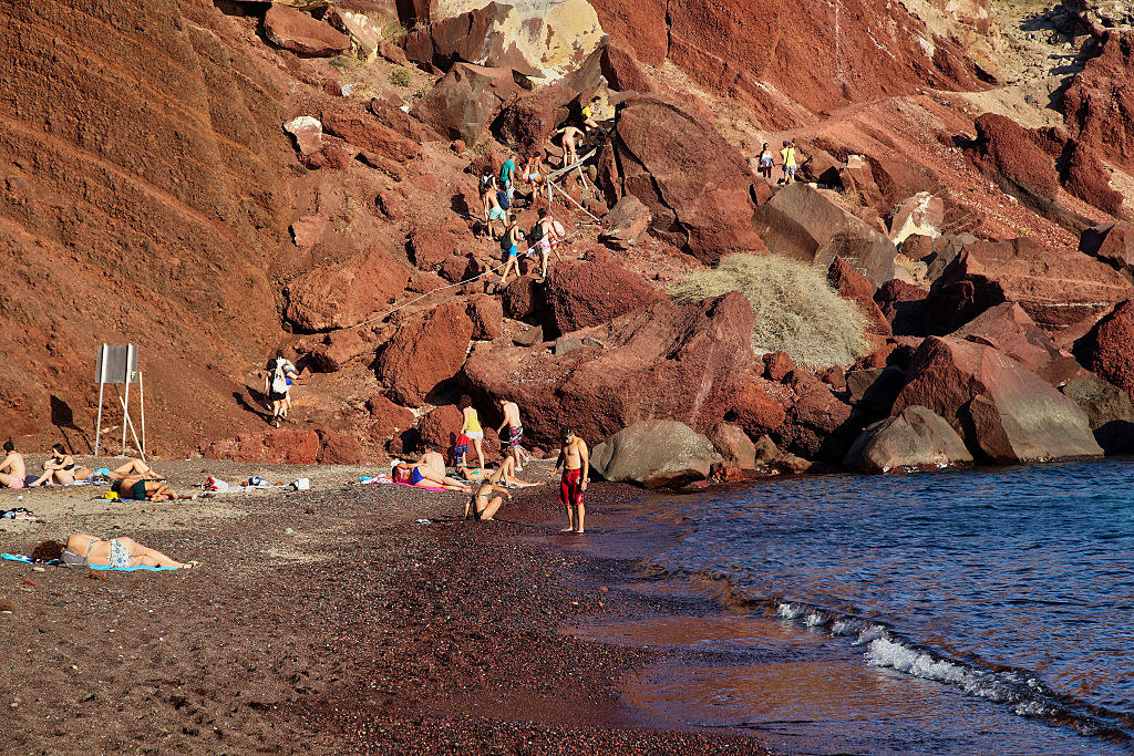 People on the rocky steps to Red Beach