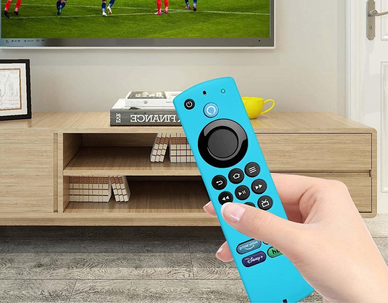 person holding the remote with the case on pointed at a TV