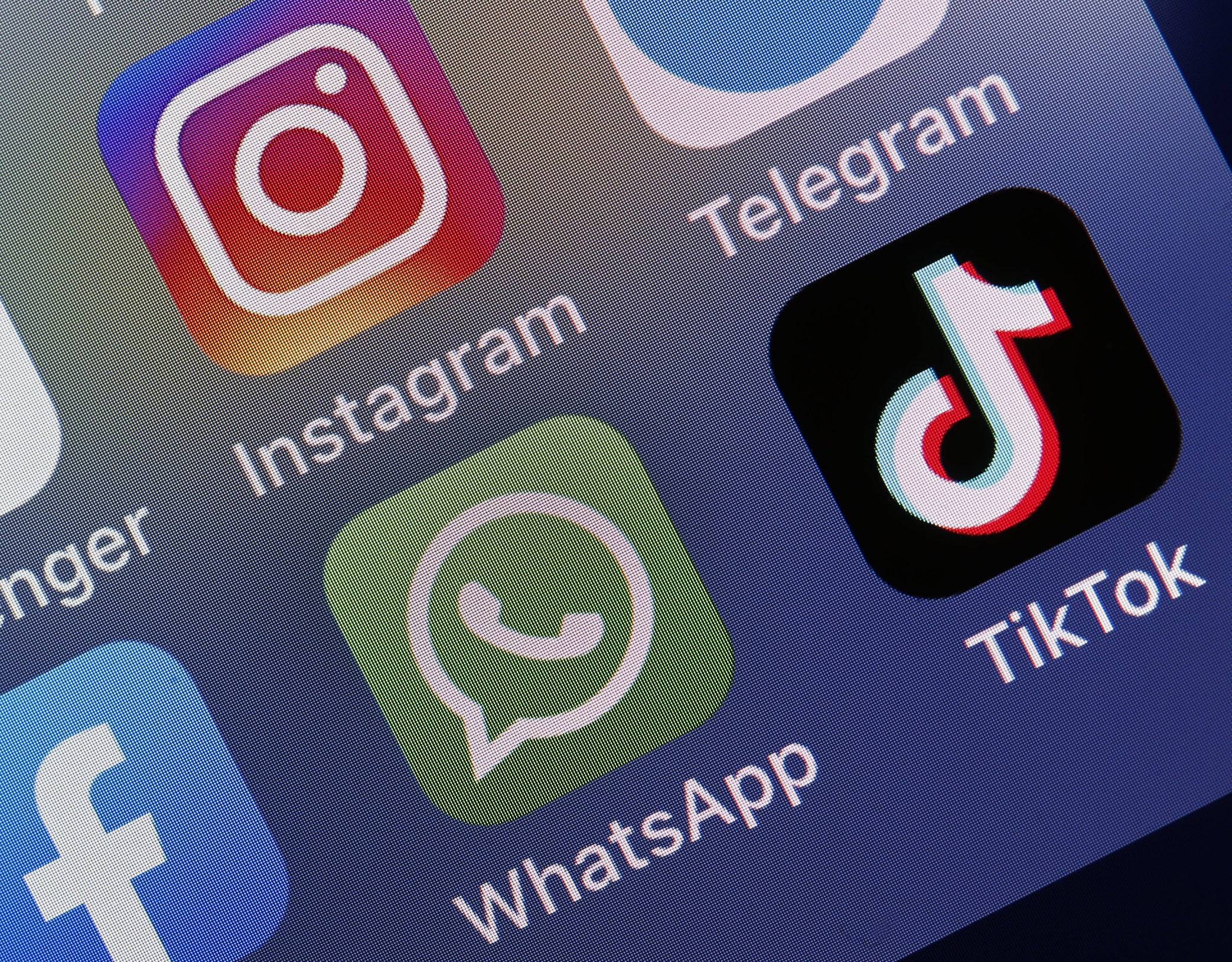 logos of social media applications, Messenger, Instagram, Facebook, WhatsApp and TikTok is displayed on the screen of an iPhone