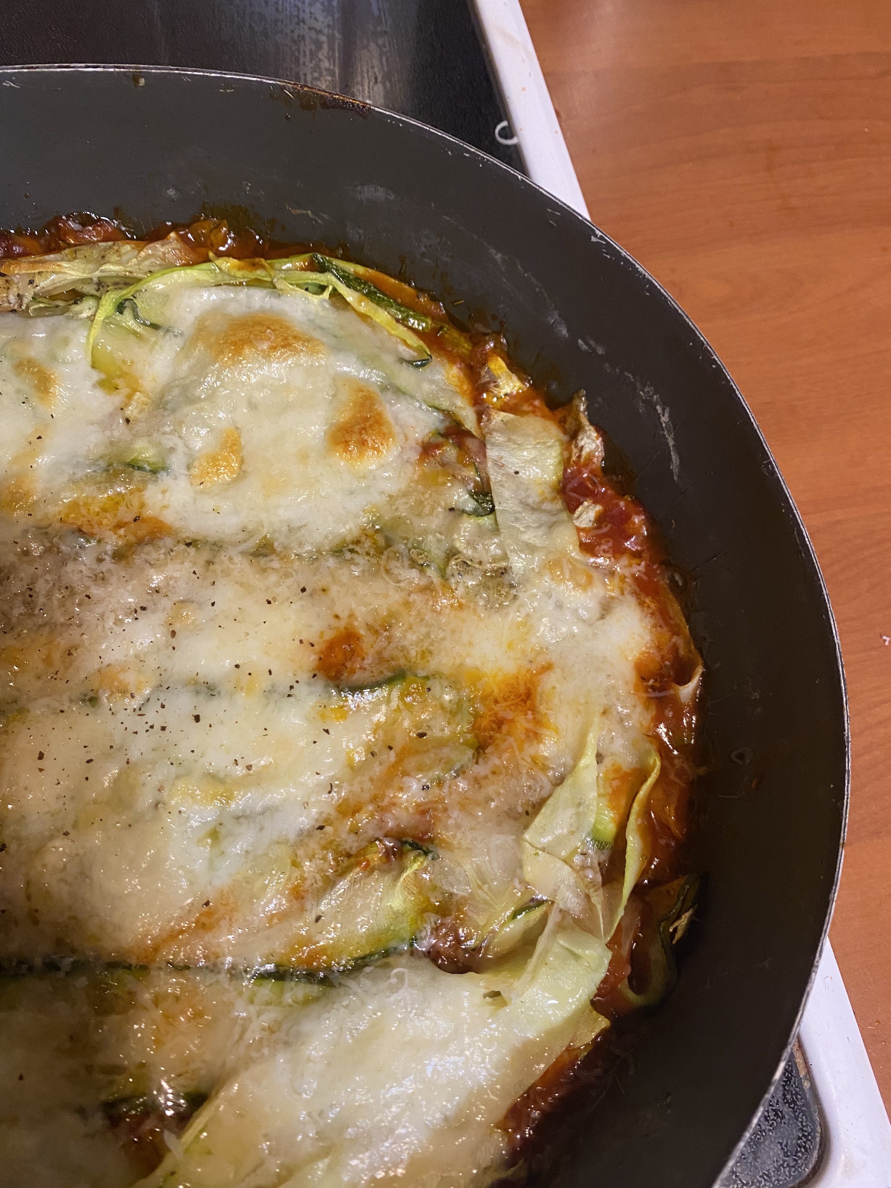 Cheesy zucchini lasagna in a cast-iron skillet