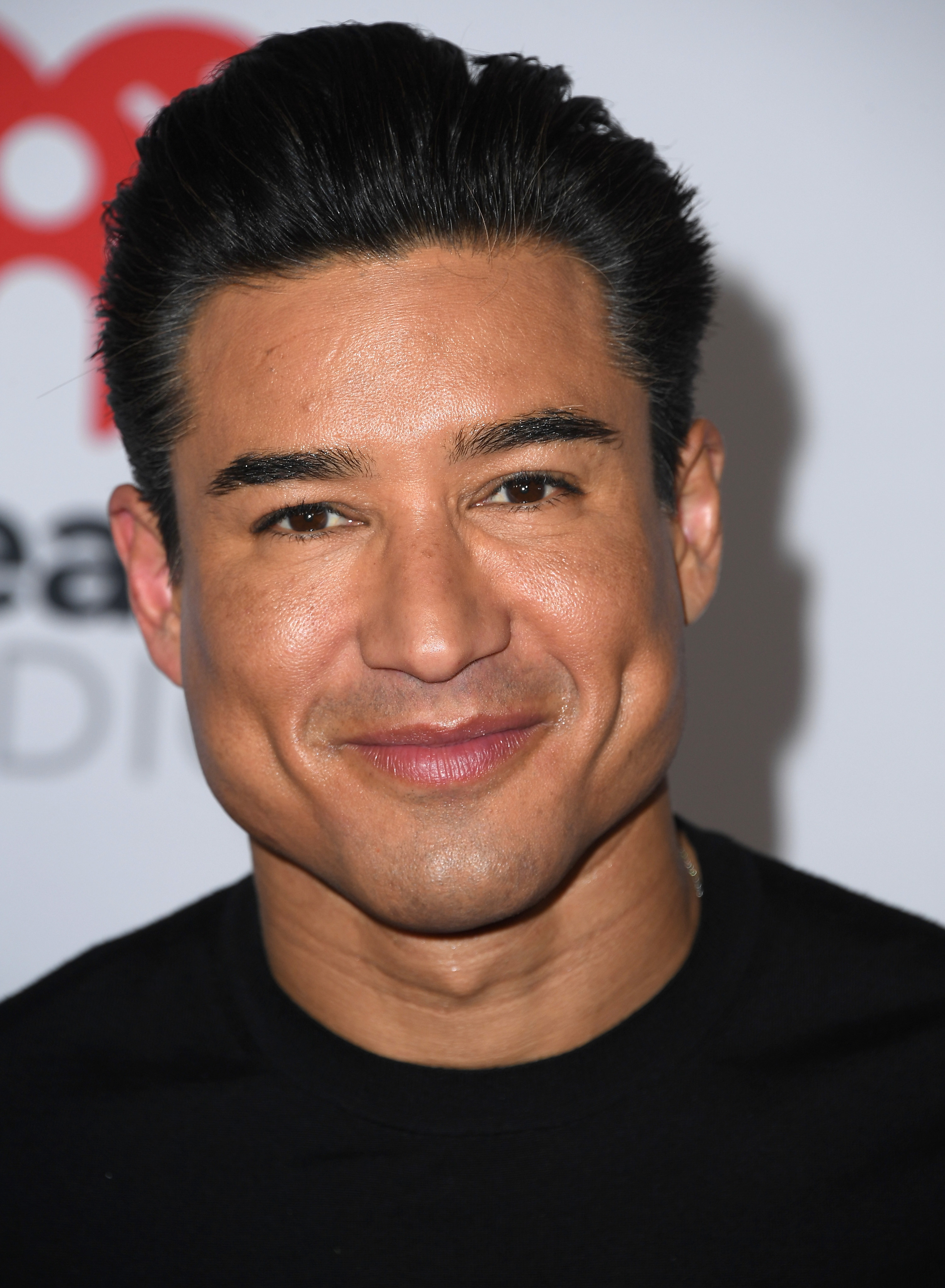 Mario Lopez in a black shirt on the red carpet in March of 2022