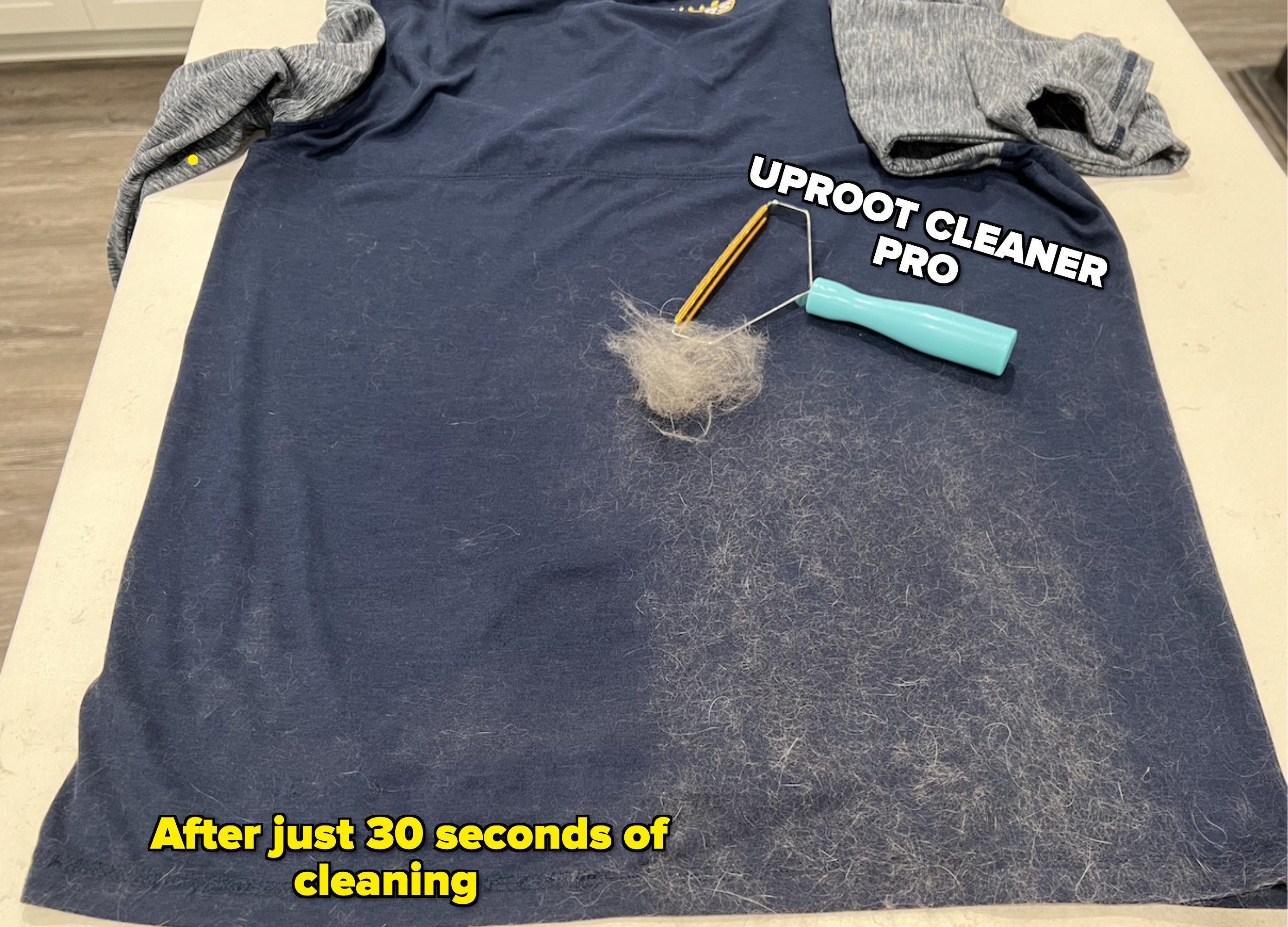 A shirt laid out, one side covered in fur and one size cleaned. The clean side is labeled &quot;after just 30 seconds of cleaning&quot; and the Uproot Cleaner Pro is laying on the shirt with a large pile of hair