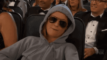 person relaxing in a hoodie and sunglasses