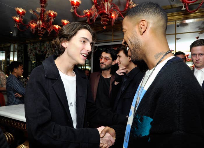 Timothée Chalamet and Kid Cudi shaking hands