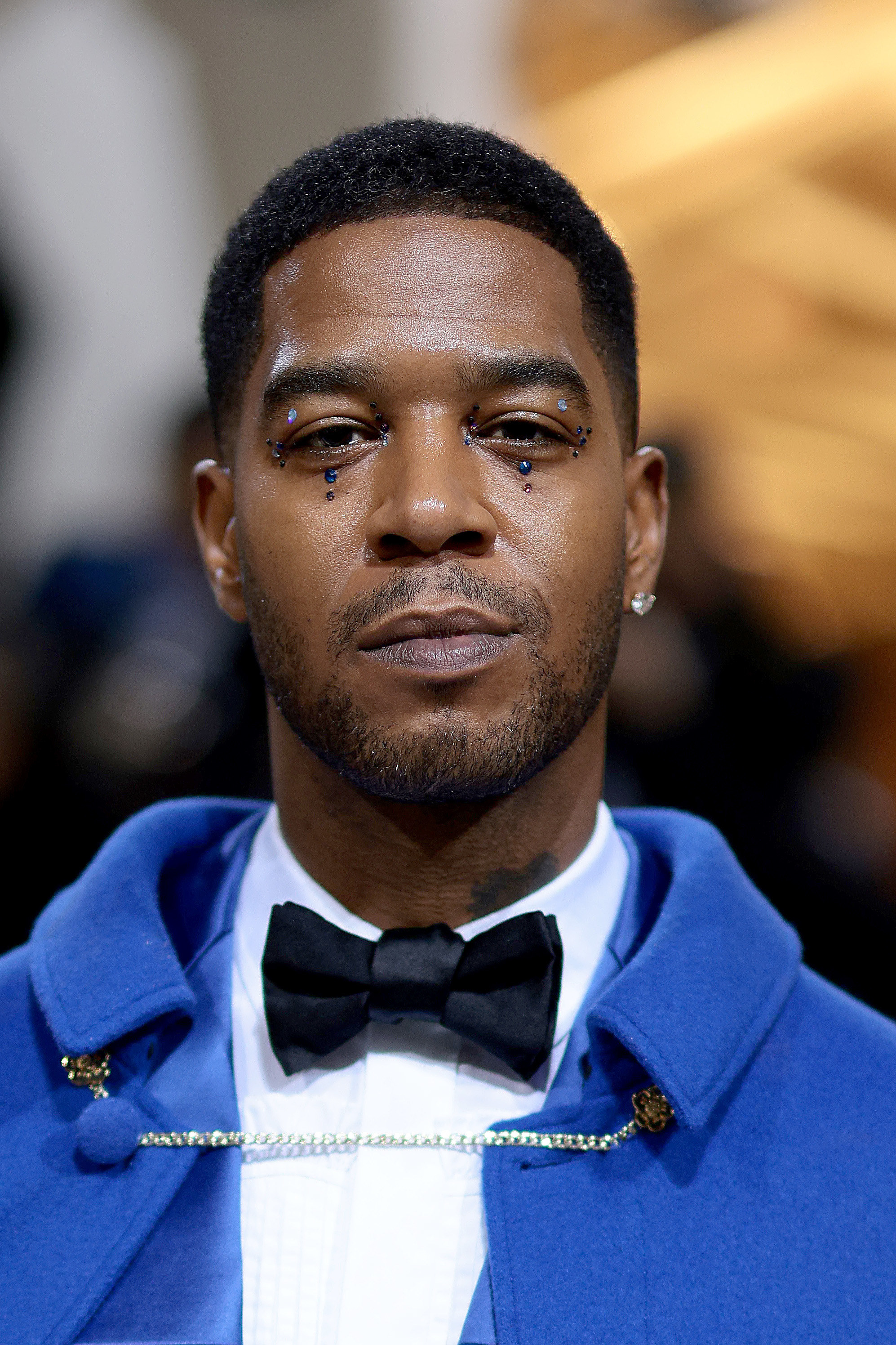 Closeup of Kid Cudi whose eyes are bejeweled