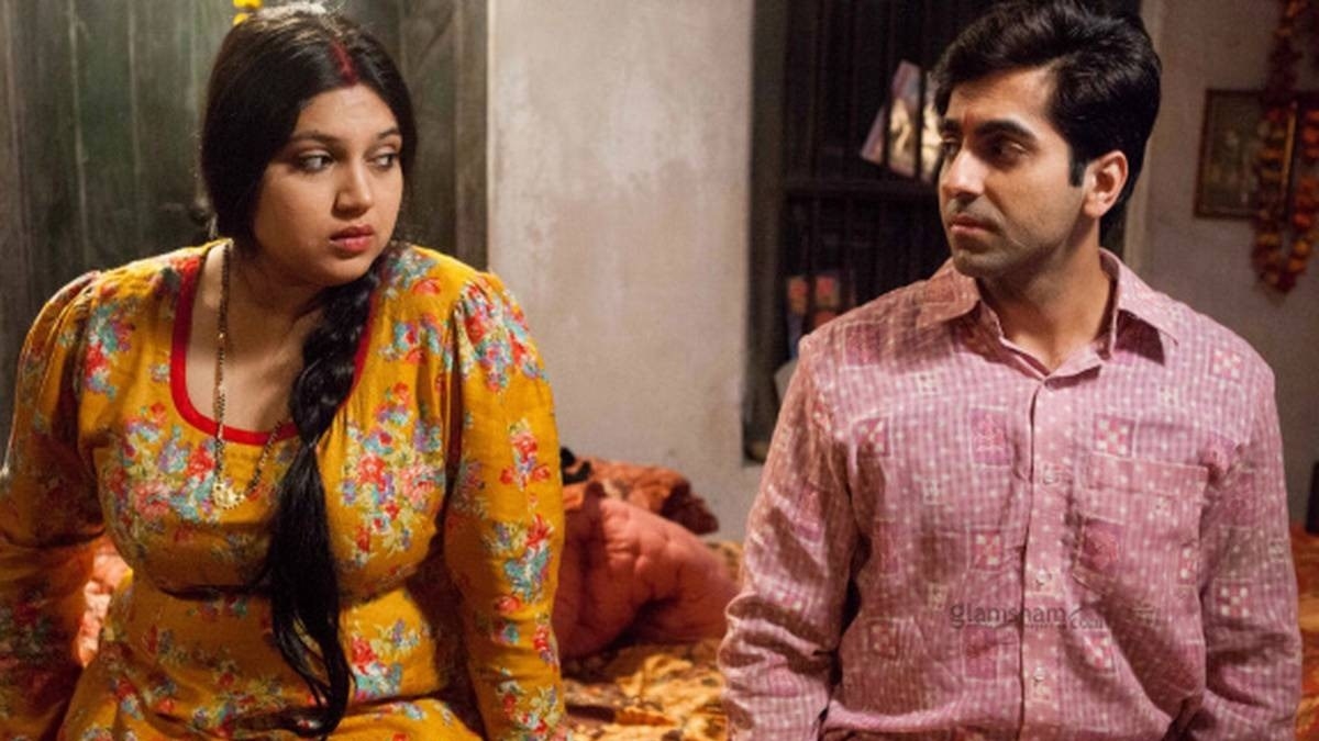 Bhumi Pednekar and Ayushmann Khurrana sitting on a bed and looking at each other in a still from the film