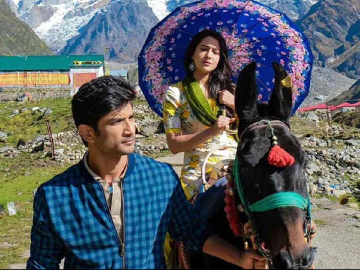 Sara Ali Khan riding on a horse with Sushant Singh Rajput leading the horse up a mountain in a still from the movie