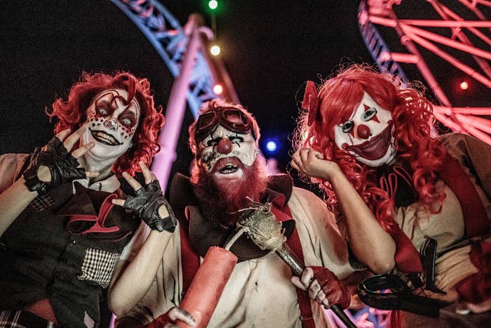 A trio of creepy clowns strike a petrifying pose at Knott’s Scary Farm.