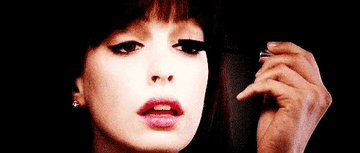 Anne Hathaway in The Devil Wears Prada applying mascara