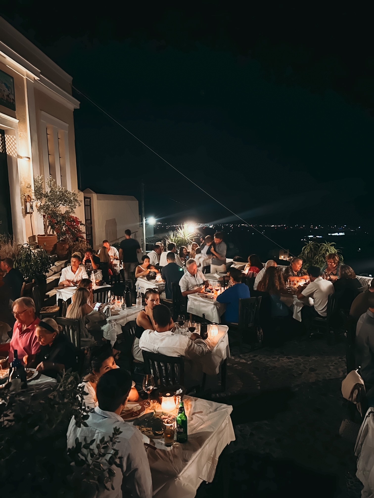 People dining outdoors at night.