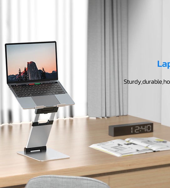 a laptop on the lifted stand on a minimalist desk