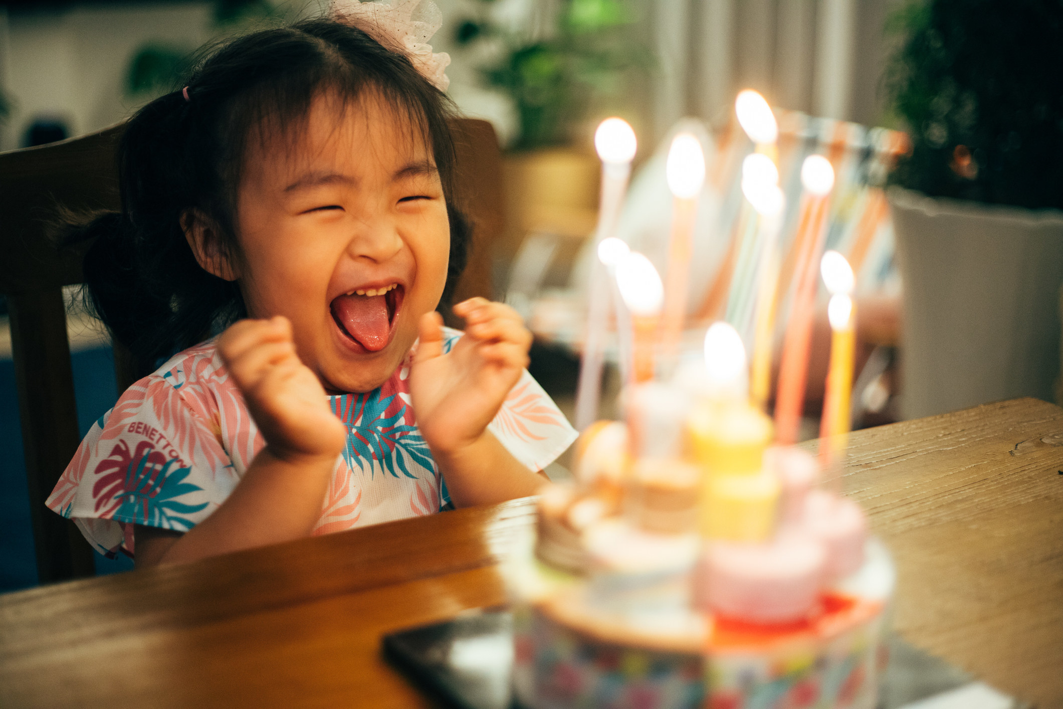 A little girl smiling at her birthday cake