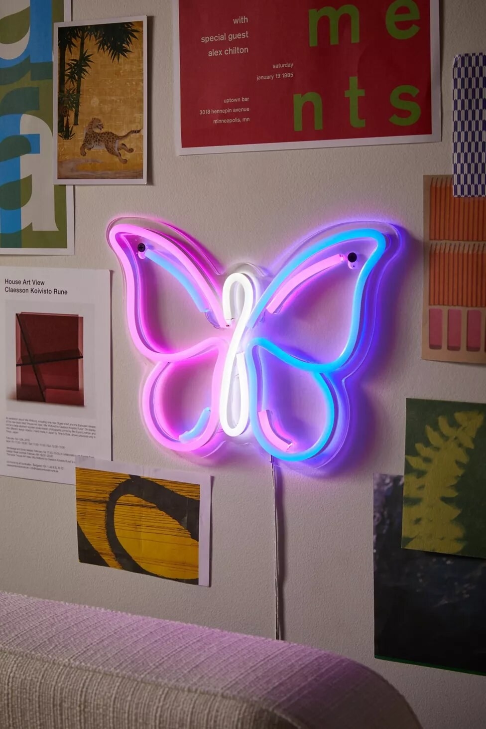 the neon butterfly sign on a wall