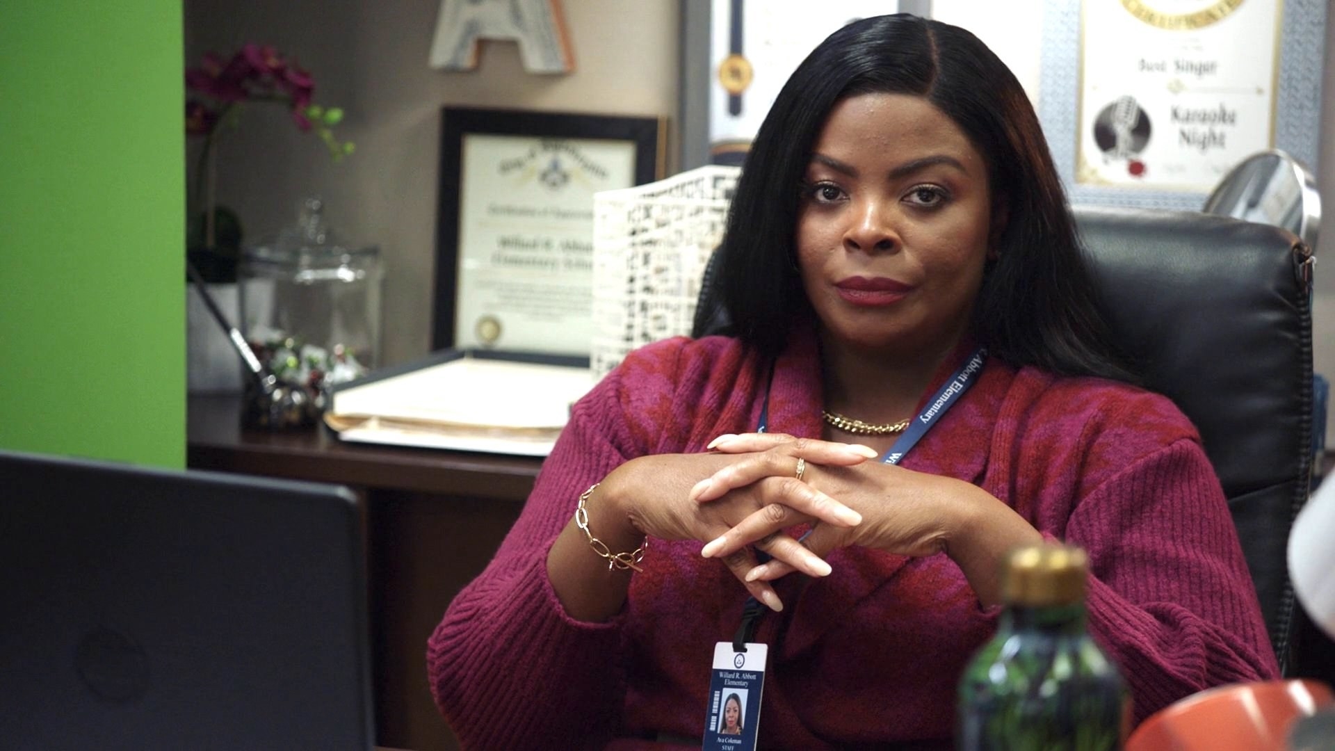 a principal sitting in her office looking judgmental