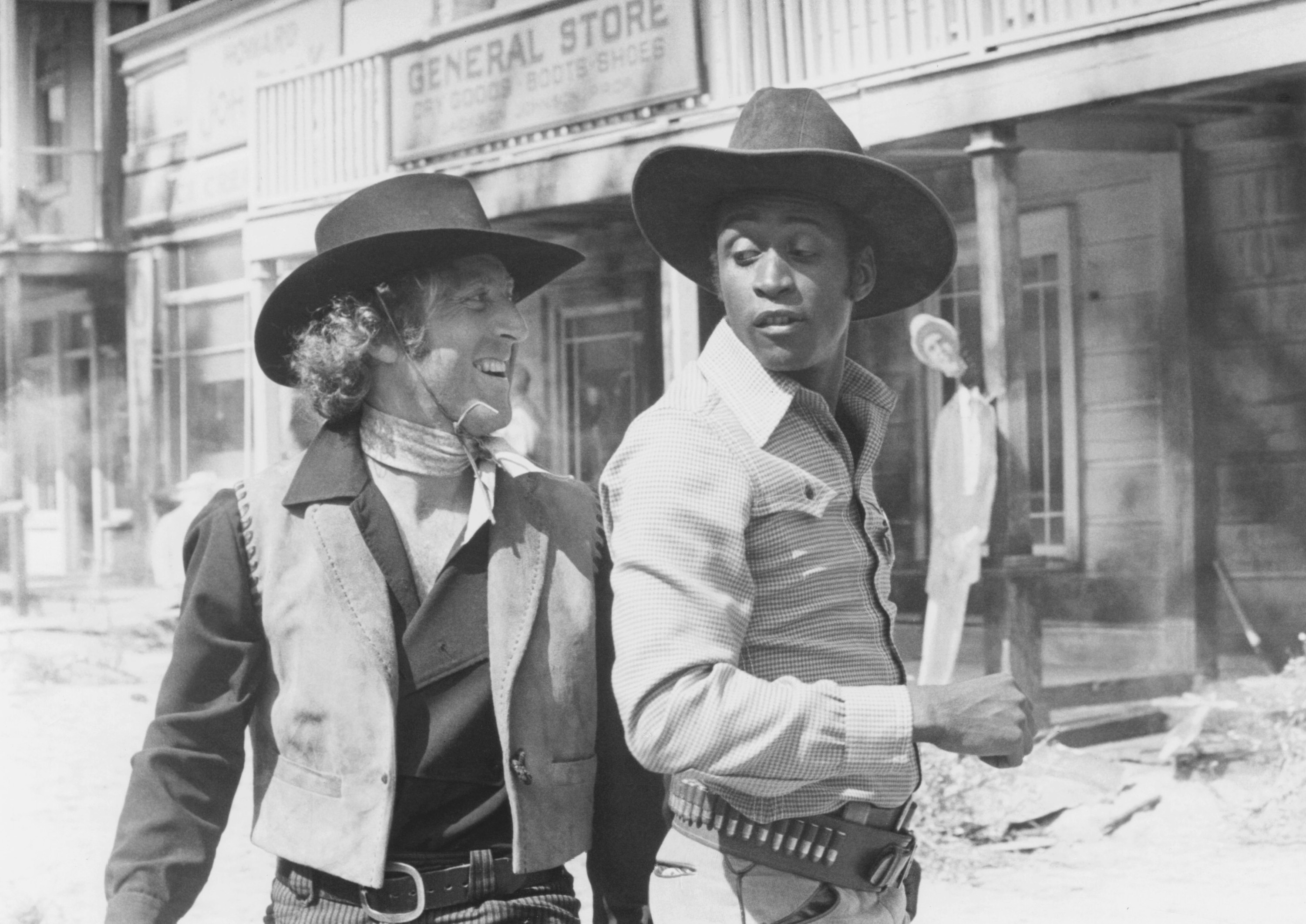 Gene Wilder and Cleavon Little stand in a town street