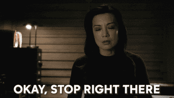 GIF of Agent Mei in Agents of SHIELD standing up and doing a &quot;stop&quot; hand gesture