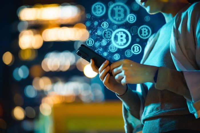 Bitcoin symbols emitting from a smartphone