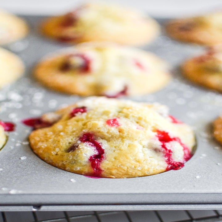 A cranberry muffin in a muffin tin.
