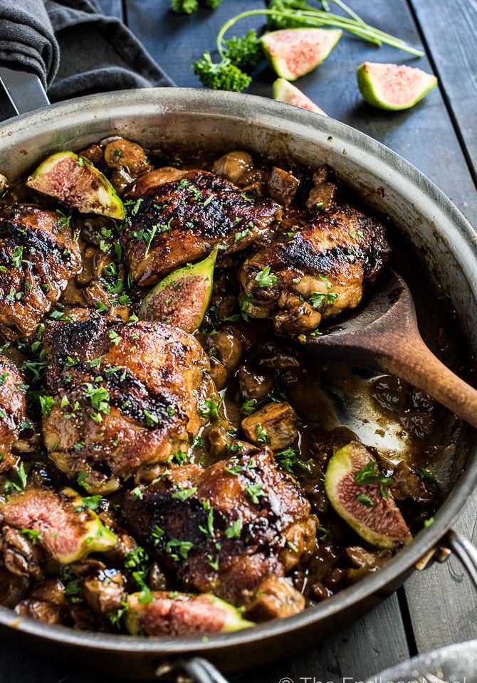 A skillet of chicken with figs.