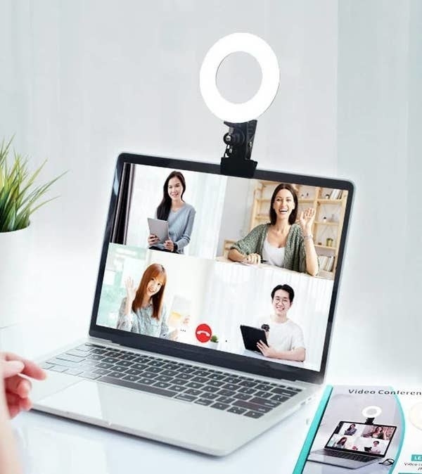 a ring light clipped to the top of a laptop