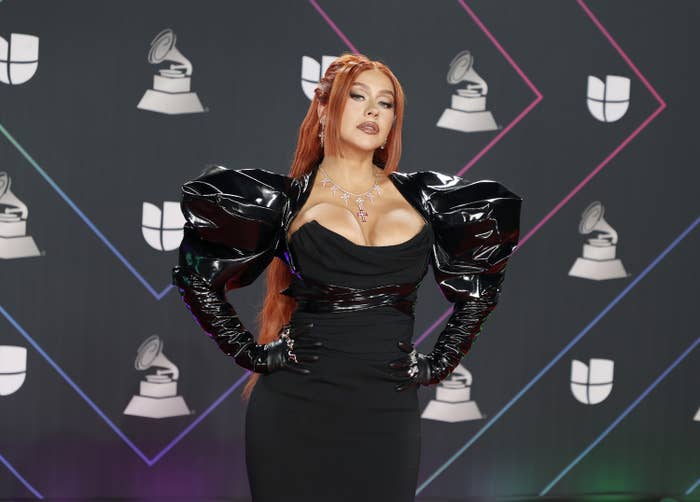 Christina poses on the Latin Grammys red carpet in a strapless dress and a bolero with puffed sleeves