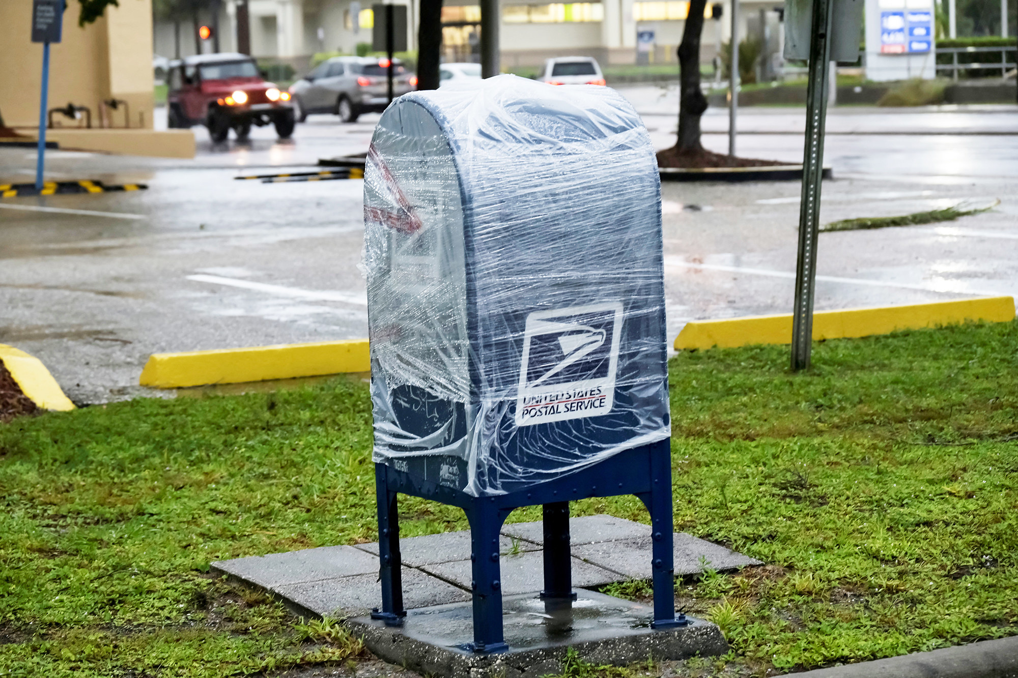 A public mailbox stands encased in shrink wrap