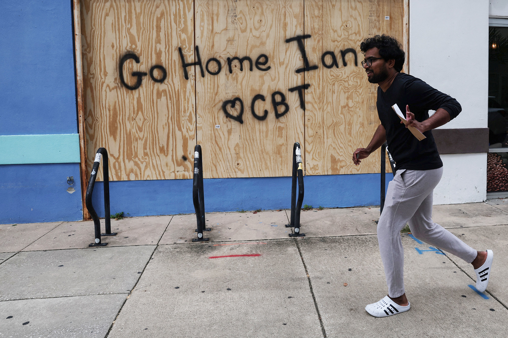 Spray paint on boards reads &quot;Go Home Ian&quot; and &quot;♥ CBT&quot;