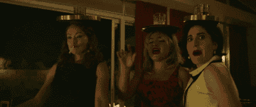 Olivia Wilde, Florence Pugh, and Kate Berlant dancing with whiskey glasses on their heads as their Don&#x27;t Worry Darling characters