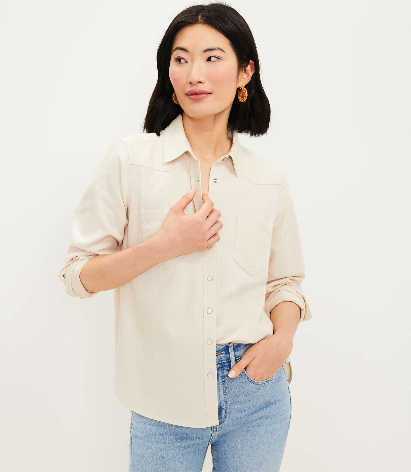 A model in the cream blouse