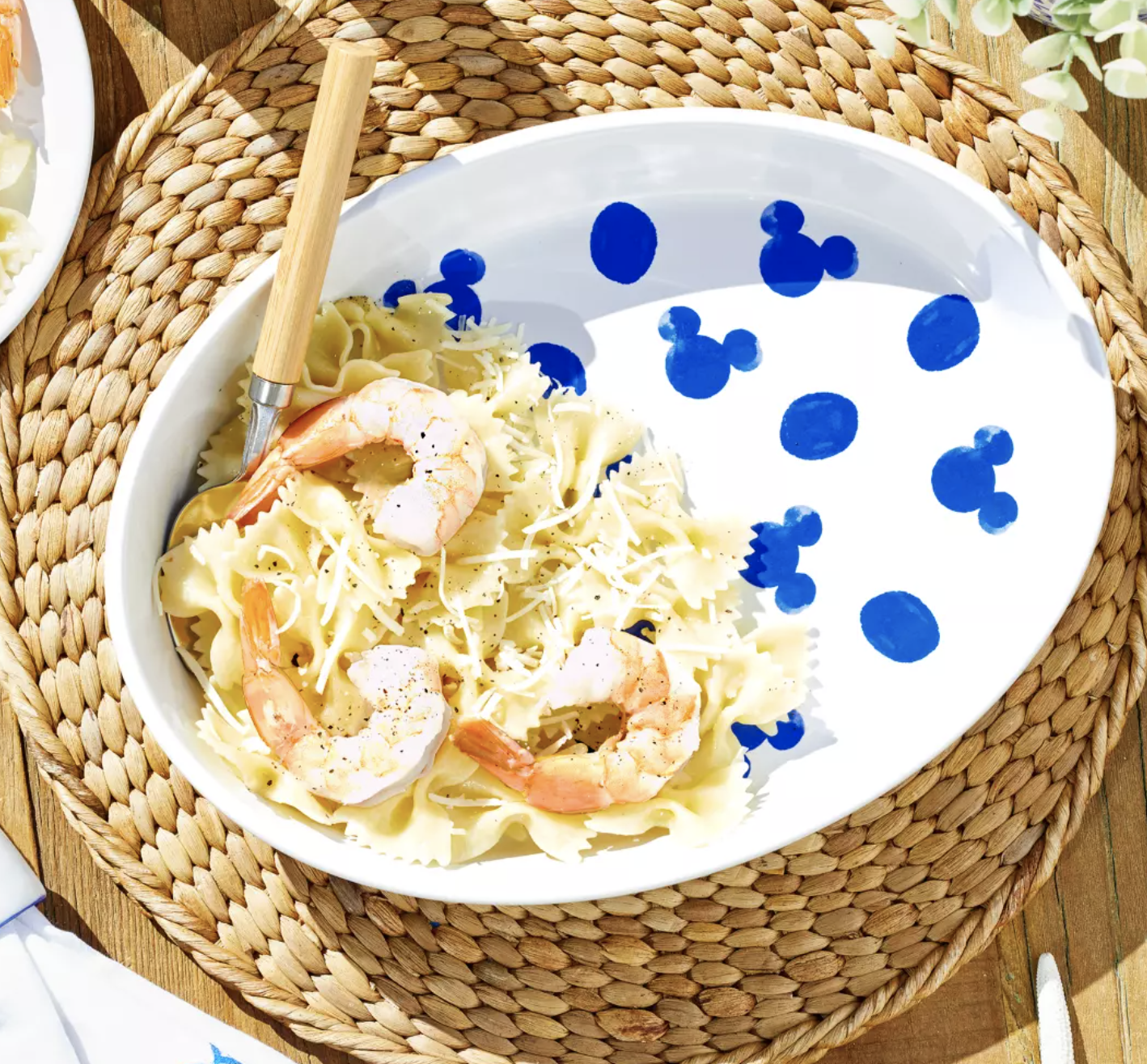 A blue and white Disney tray filled with shrimp and pasta