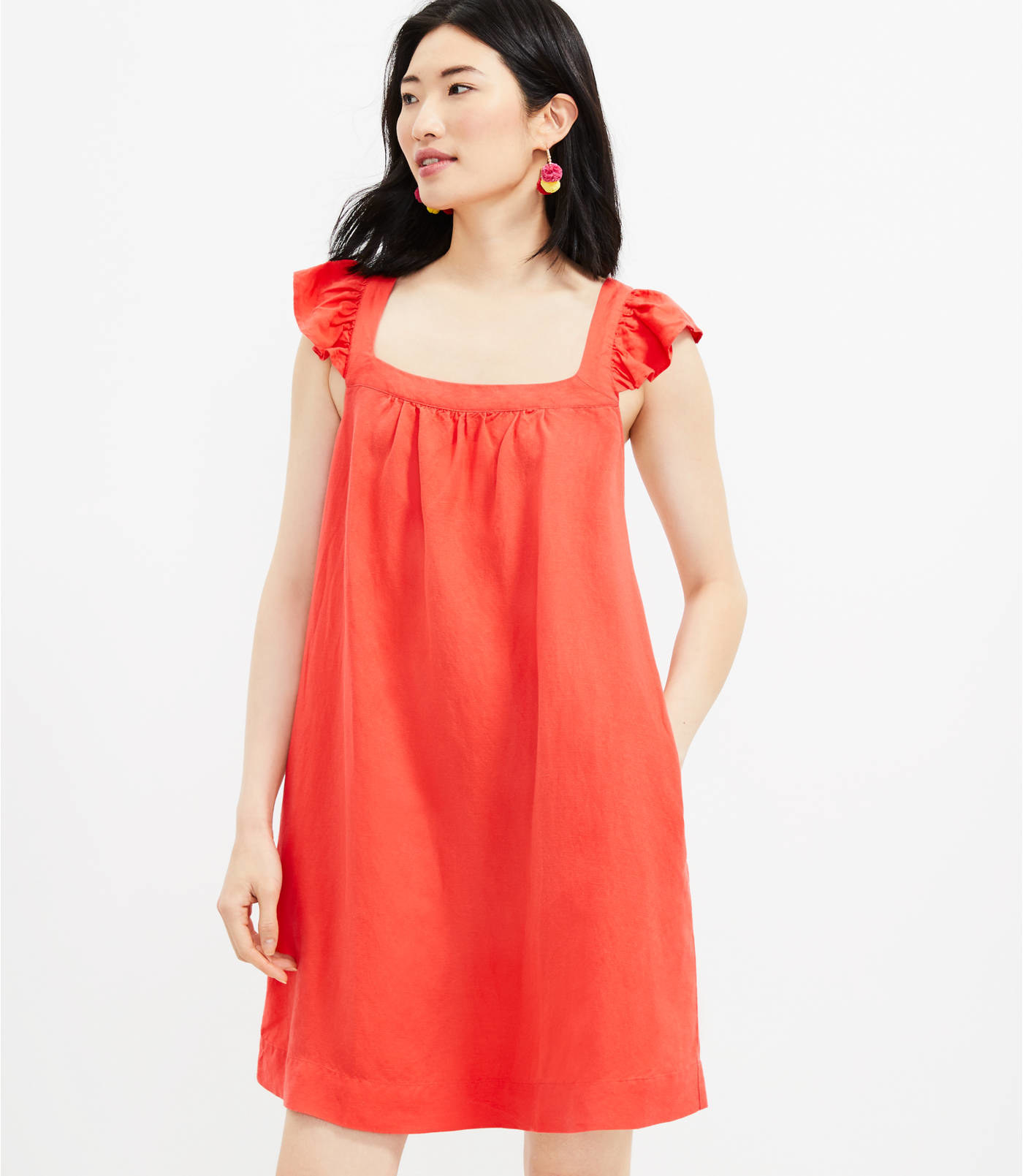 A model wears the sleeveless dress in red