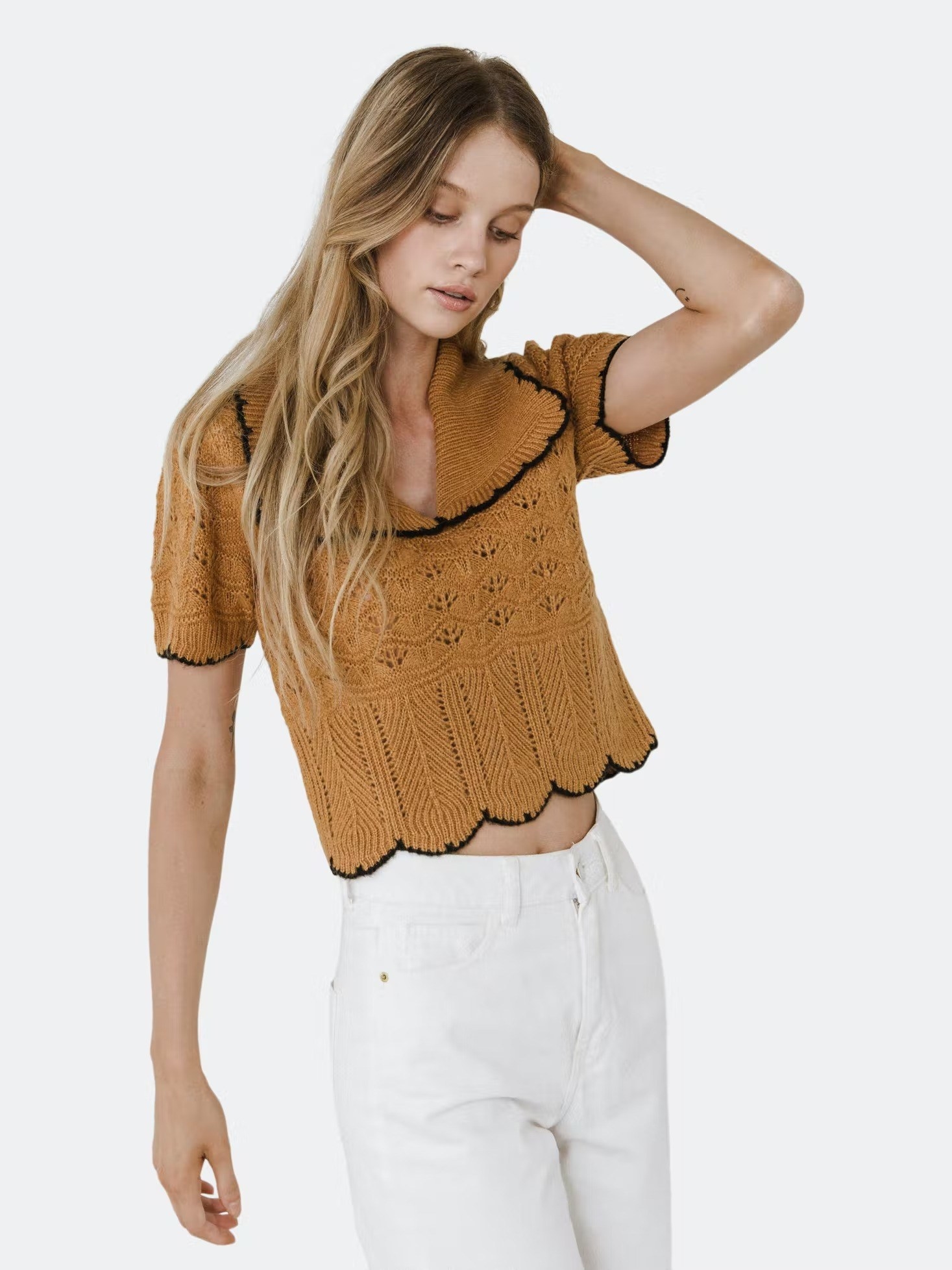 A model wearing the Short Puff Sleeve Scalloped Knit Top in camel