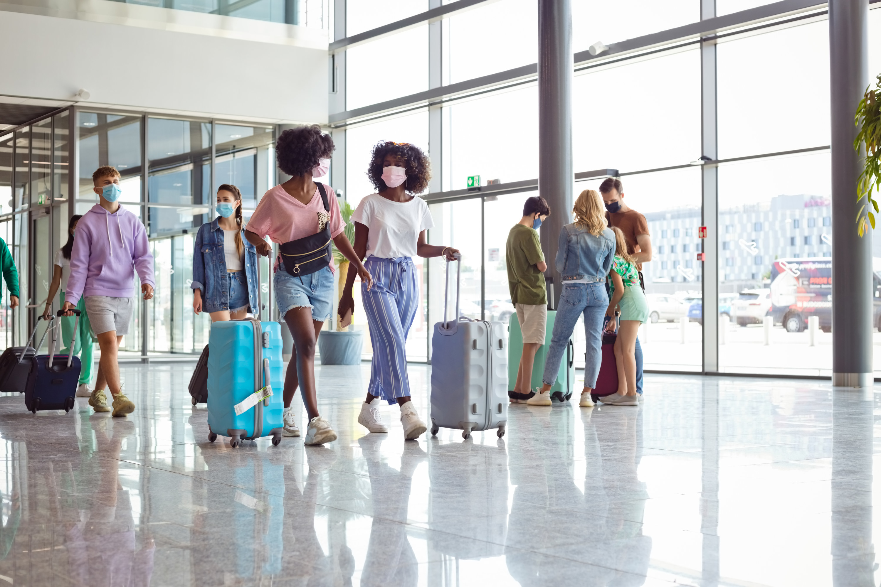 a group of people walking in an airport