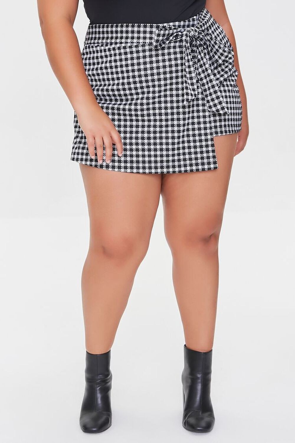 Model wearing the black and white plaid skort