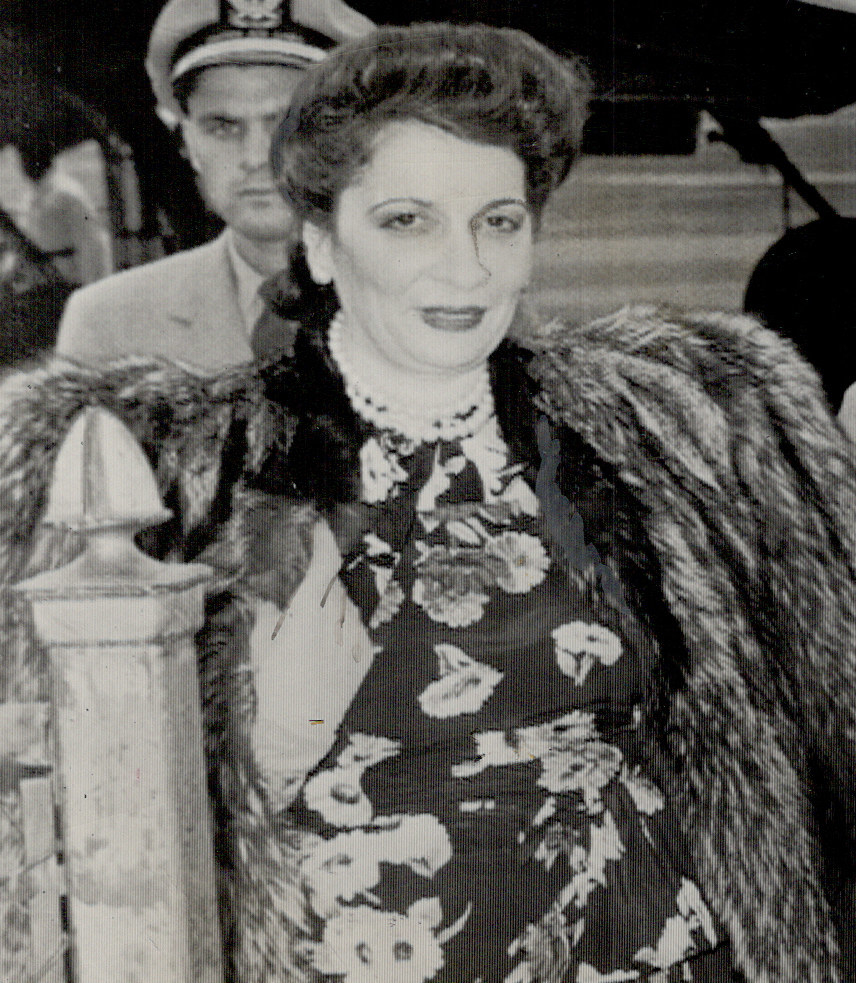 Black-and-white photo of a smiling woman wearing a fur coat