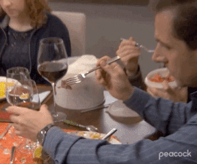 Michael putting food in a glass of wine