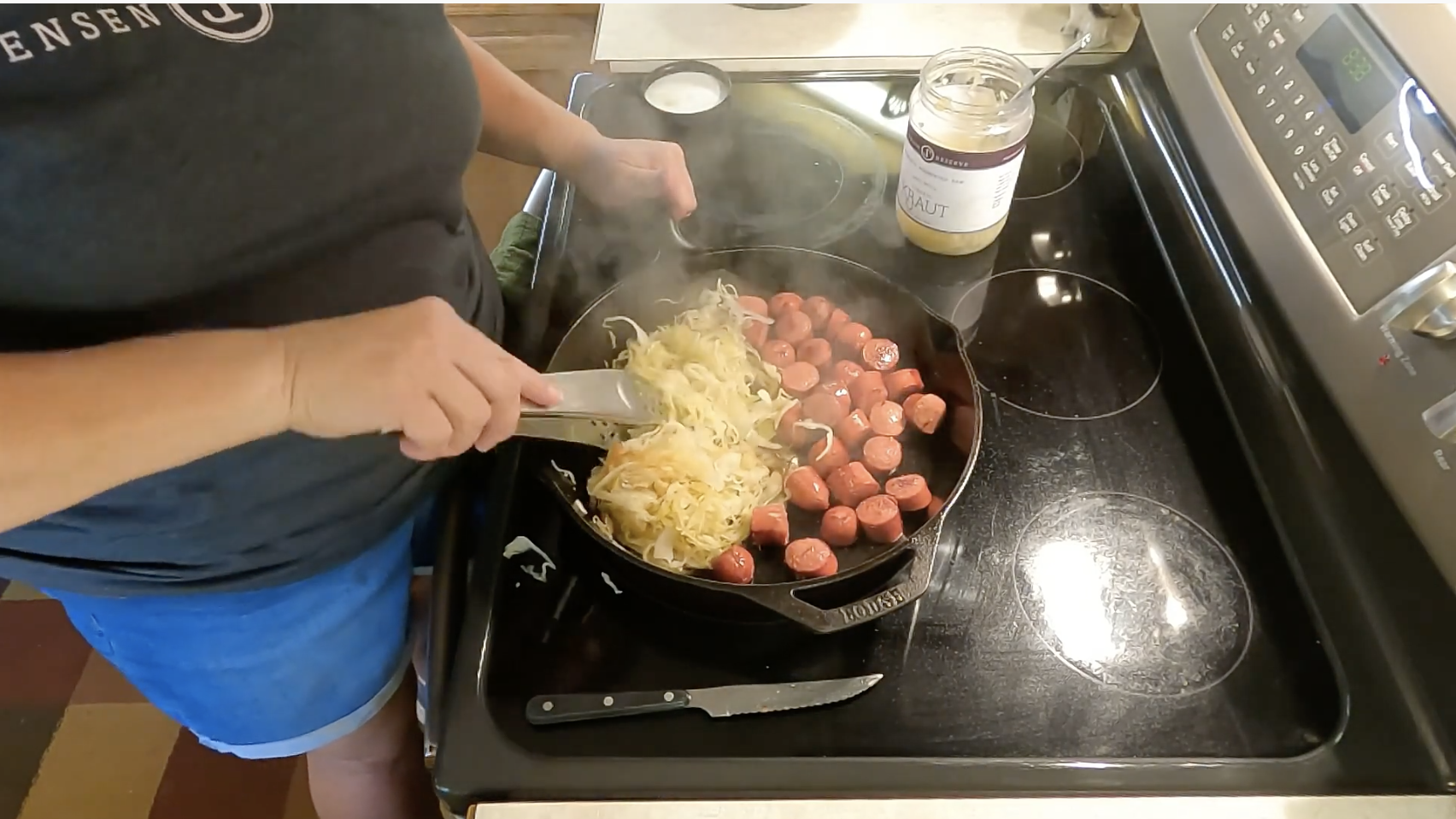 Sauerkraut and hot dogs cooking in a pan