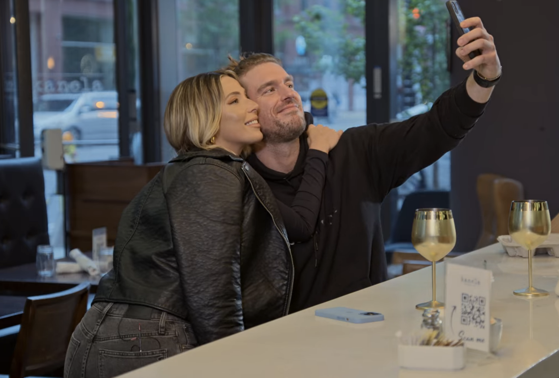 Shayne taking a selfie in a restaurant with a woman
