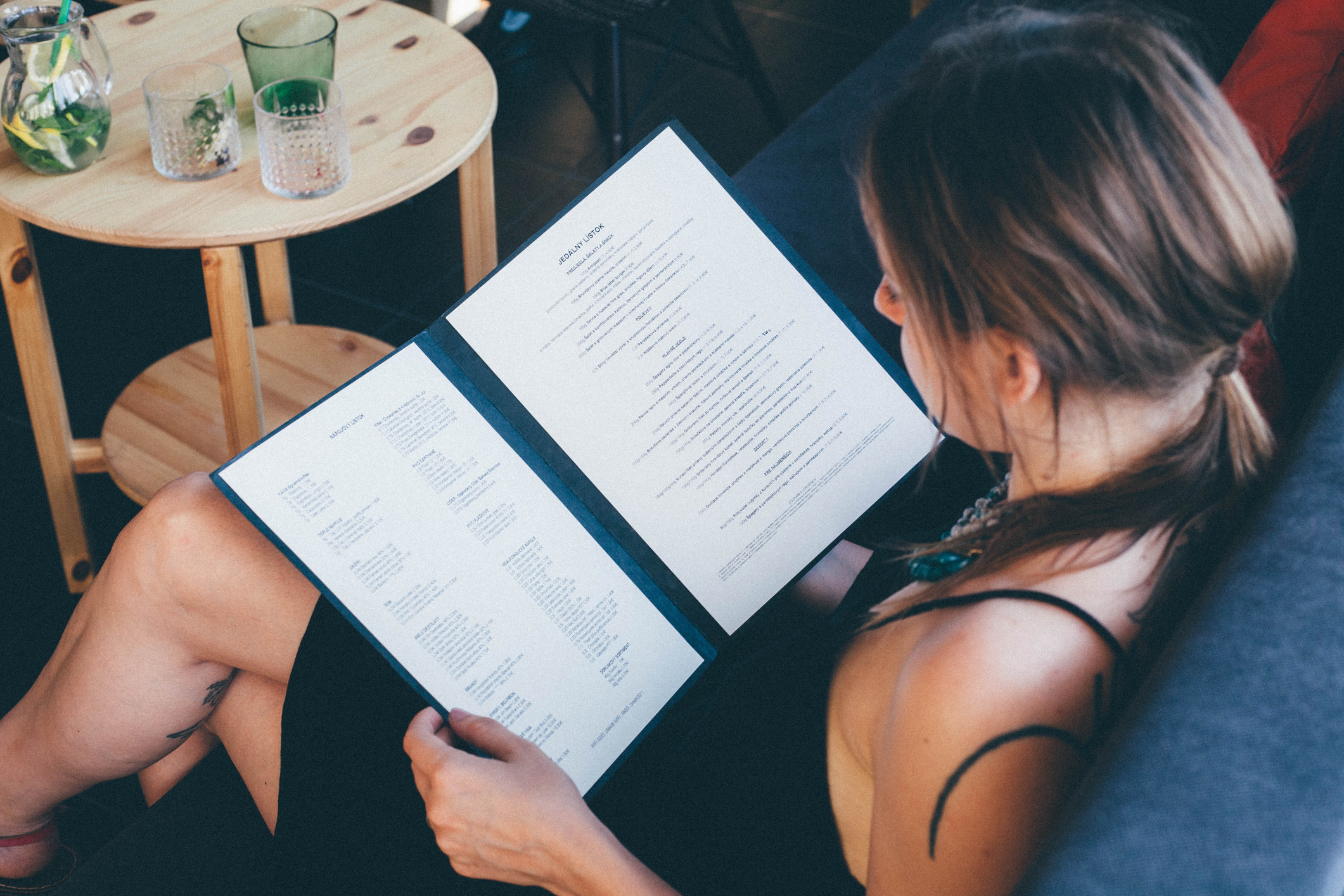 person reading a menu at a table