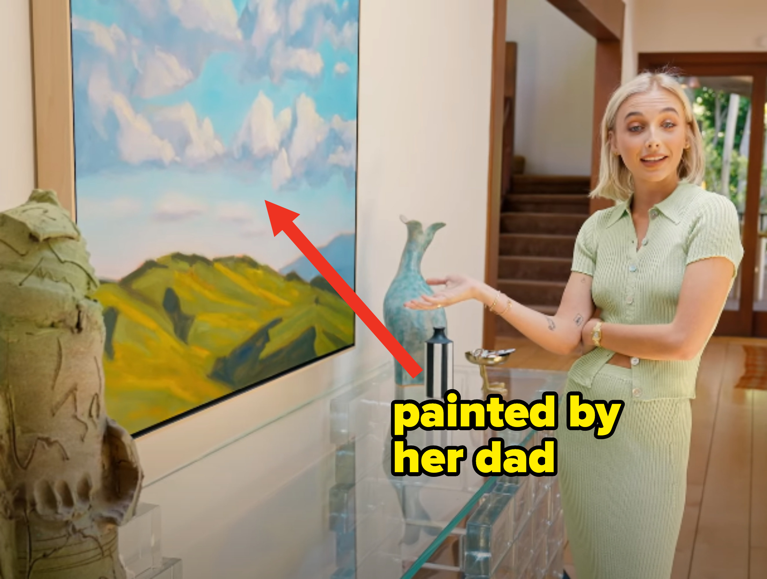 Emma showing a painting by her dad