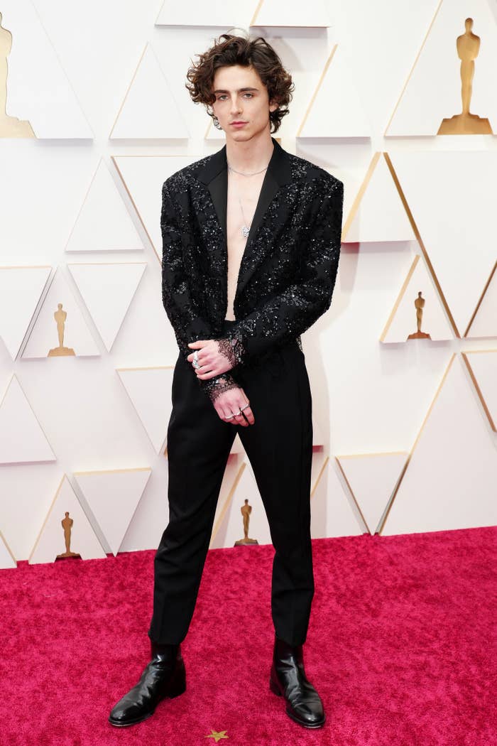 timotee in a shiny blazer with no shirt underneath on the red carpet