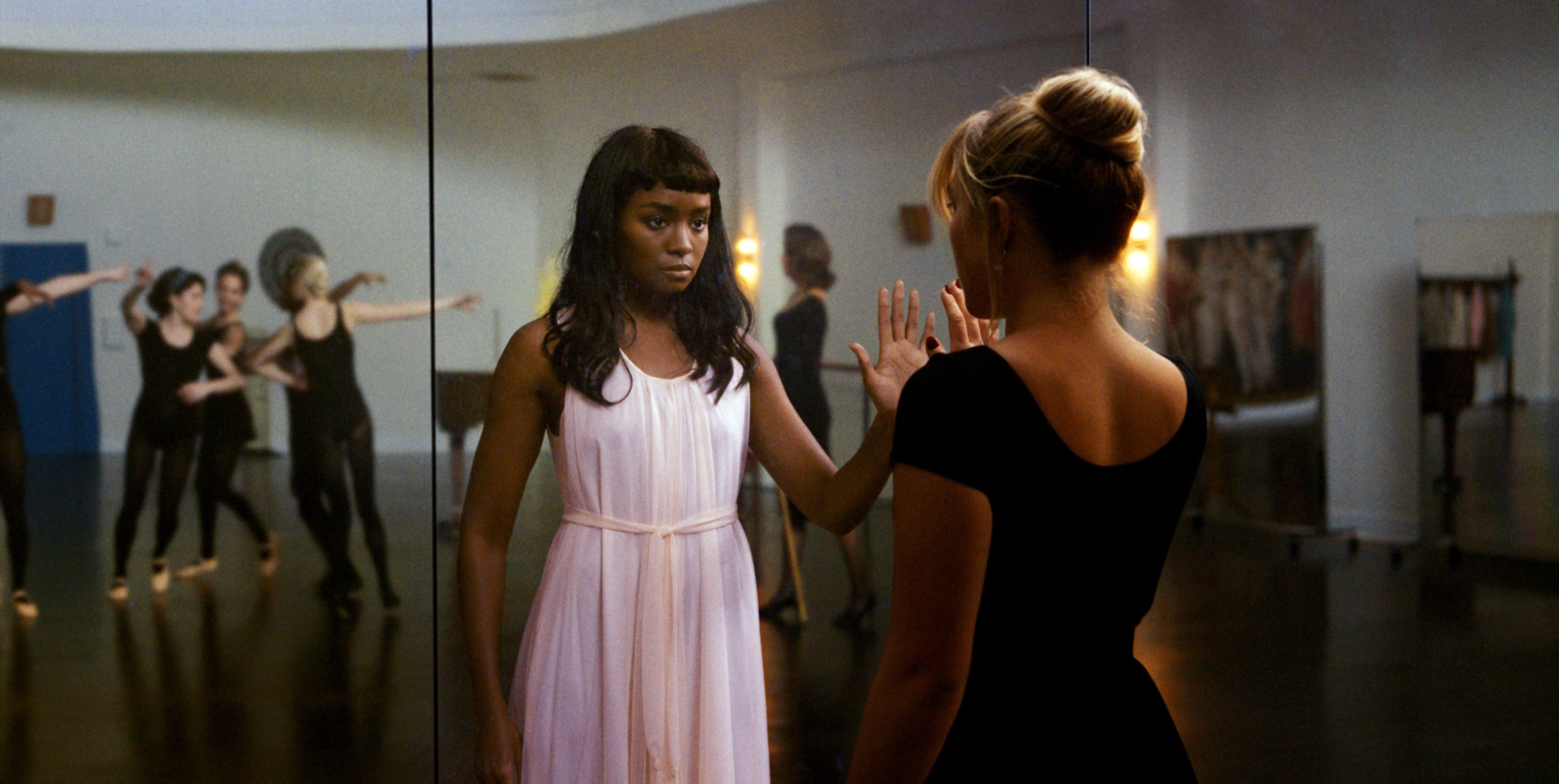 Margaret in the reflection of the mirror in a dance class