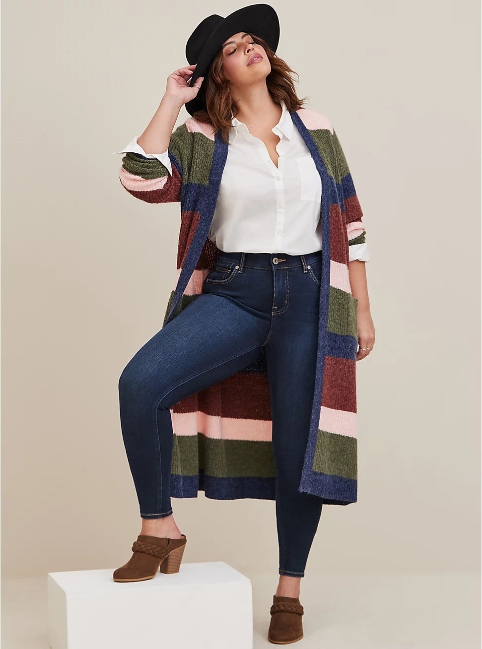 model posing in a long cardigan and jeans
