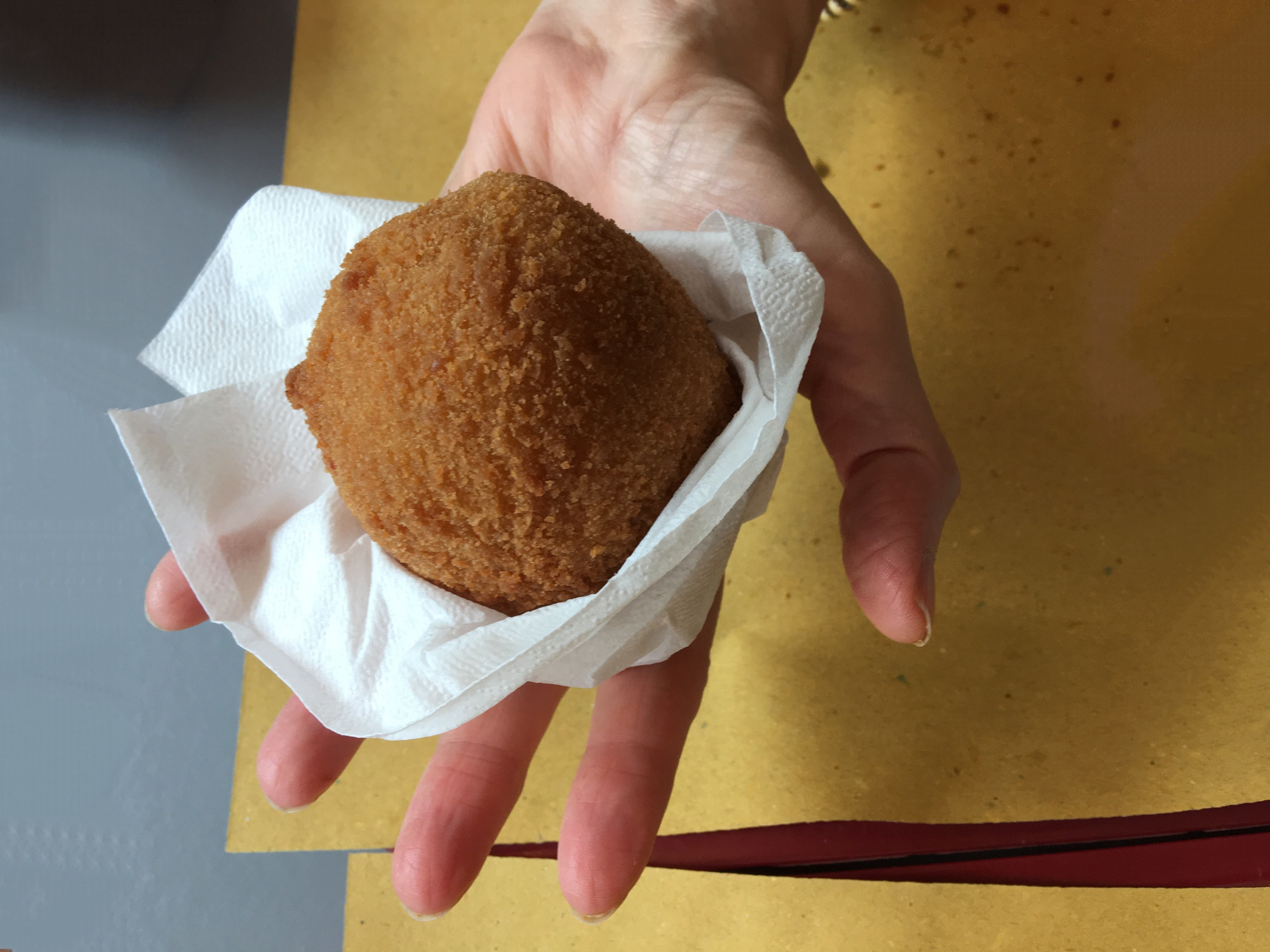A fried rice ball in a hand