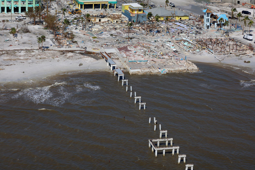 Most of the pier is gone and there is debris on the beach