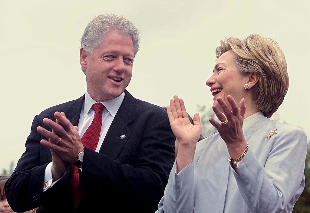 closeup of Hillary and Bill clapping and looking at each other
